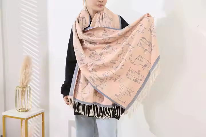 Person wearing a pink scarf with fringe details on a white background