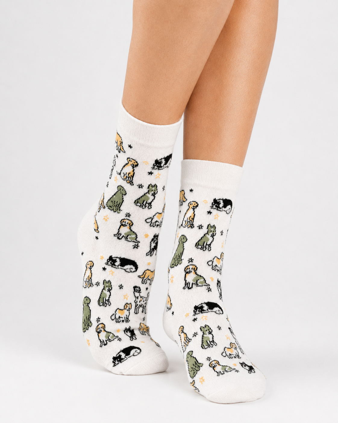 White socks with dog pattern worn by a person on a light gray background