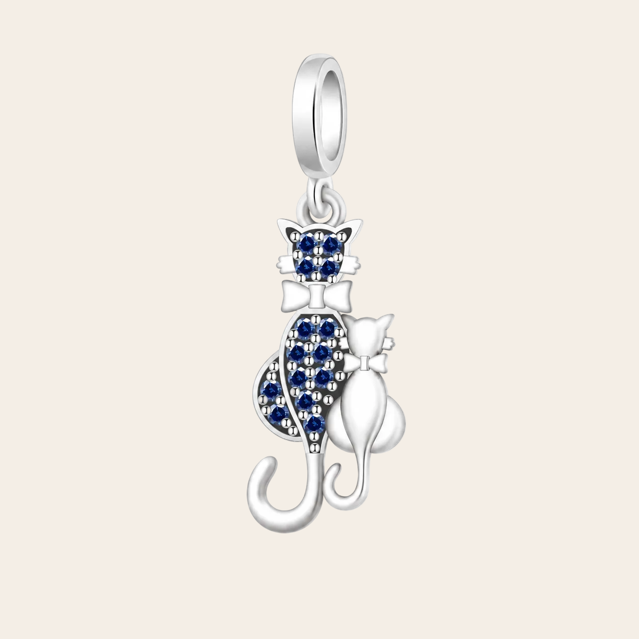 A silver cat-shaped pendant charm featuring one larger cat and one smaller cat, both detailed with sparkling blue stones, set against a clean white background.