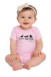Baby wearing a pink 'Cat Sister' onesie on a white background