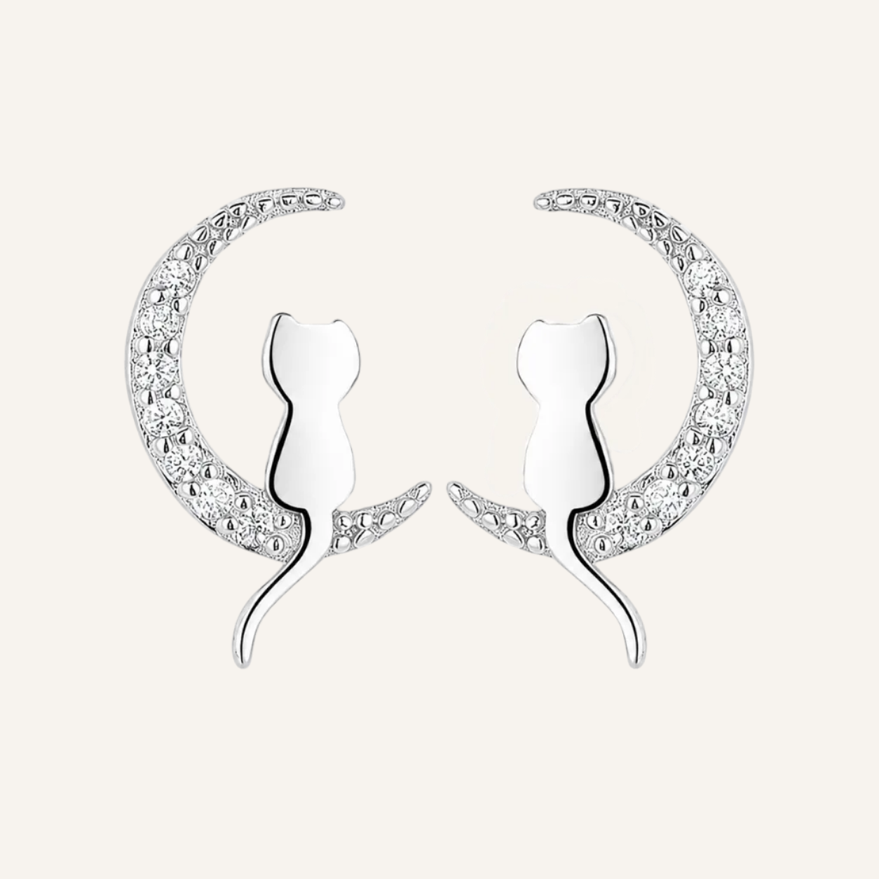 A pair of silver crescent moon stud earrings featuring a stylized cat silhouette in the center, set with small clear stones along the outer curve, on a plain white background.