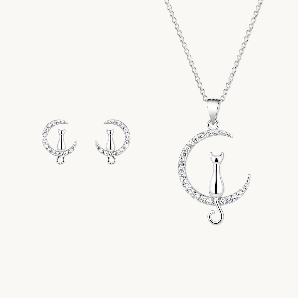 Silver jewelry set with cat and moon design on a white background