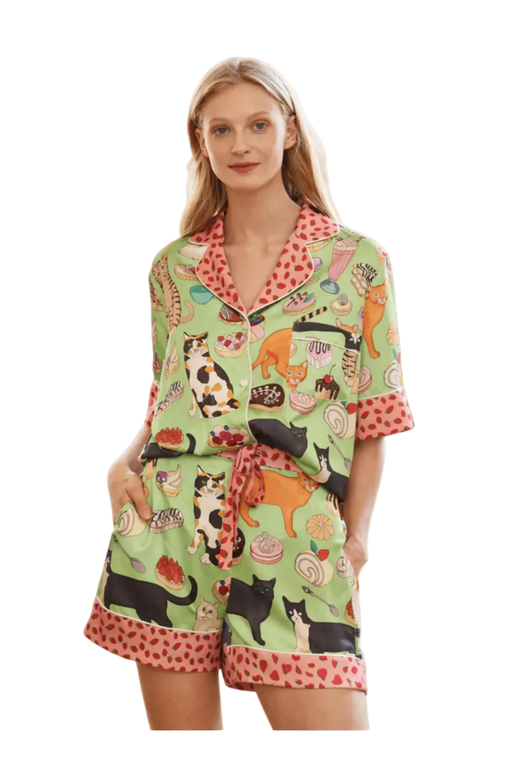 Woman wearing a green pajama set with animal print on a white background