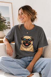 Woman wearing a gray t-shirt with a pug graphic sitting on a couch.