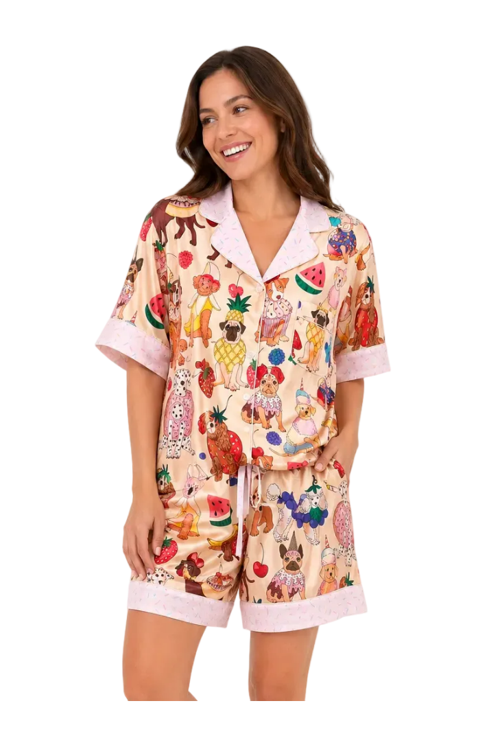 Woman wearing a colorful pajama set with cartoon characters on a white background