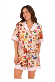 Woman wearing a colorful pajama set with cartoon characters on a white background