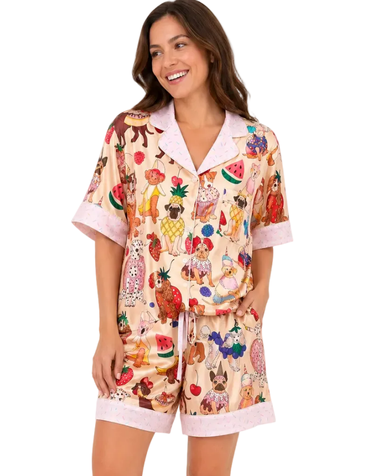Woman wearing a colorful pajama set with cartoon characters on a white background