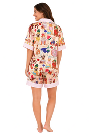 Woman wearing a colorful pajama set with animal prints on a white background