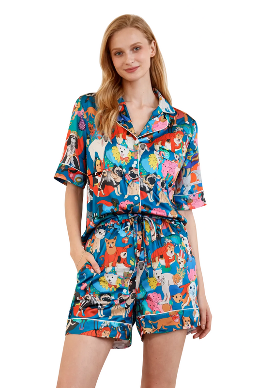 Woman wearing a colorful pajama set with animal print on a white background