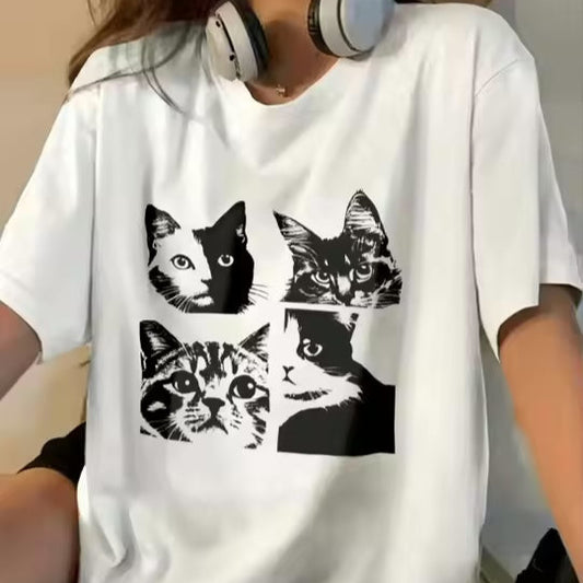Person wearing a white t-shirt with black cat illustrations.