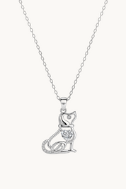 A silver pendant necklace featuring a stylized cat silhouette adorned with small clear stones, suspended from a delicate silver chain against a plain white background.