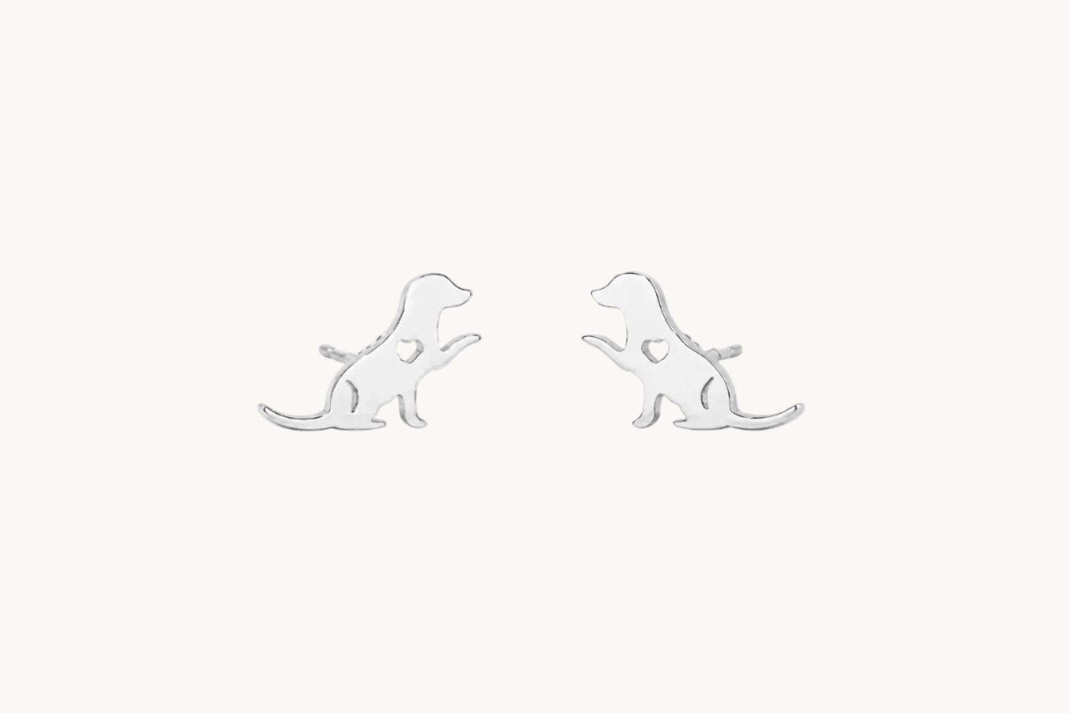 A pair of silver stud earrings shaped like sitting dogs, shown on a clean white background.
