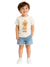 A young child wearing a cream-colored t-shirt with a cartoon dog graphic and the text 'MINIWEEK' underneath, paired with light blue denim shorts and white sneakers, standing against a plain white background.