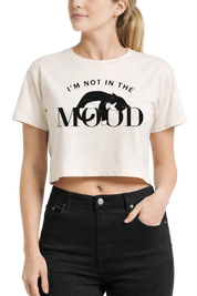 Woman wearing a white crop top with text and graphic design.