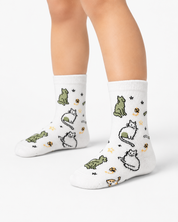 White socks with cat illustrations worn by a person on a white background