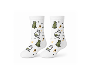 A pair of white crew socks featuring a cute pixel-art cat pattern with green, white, and black cats, small yellow flowers, and black stars.