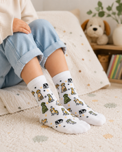 White socks with dog pattern worn by a person on a white background
