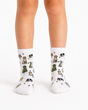 White crew socks with a playful pattern of cartoon dogs and stars, shown on a person's feet against a clean white background.