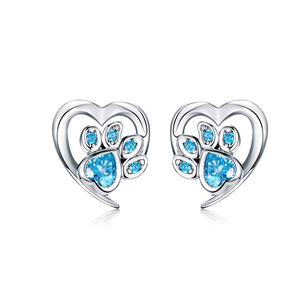 Heart-shaped earrings with paw design and blue gemstones on a white background