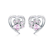 Heart-shaped earrings with pink gemstones on a white background