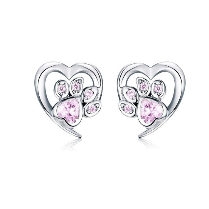Heart-shaped earrings with pink gemstones on a white background