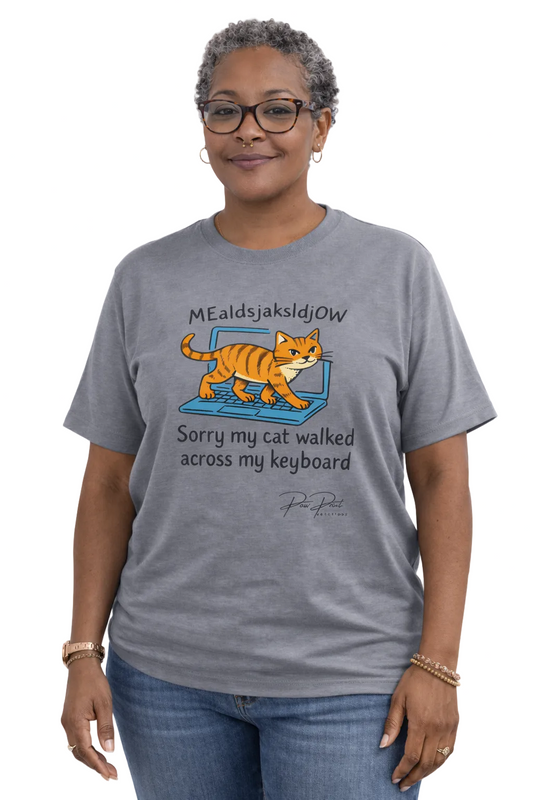 Person wearing a gray t-shirt with a cat graphic and text on a white background