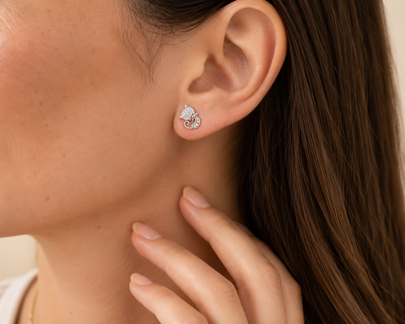 Close-up of a person wearing a silver earring with a floral design.