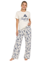 A woman modeling a two-piece pajama set consisting of an off-white t-shirt with a navy blue graphic print and matching wide-leg pants with a navy blue toile-style pattern, against a plain white background.