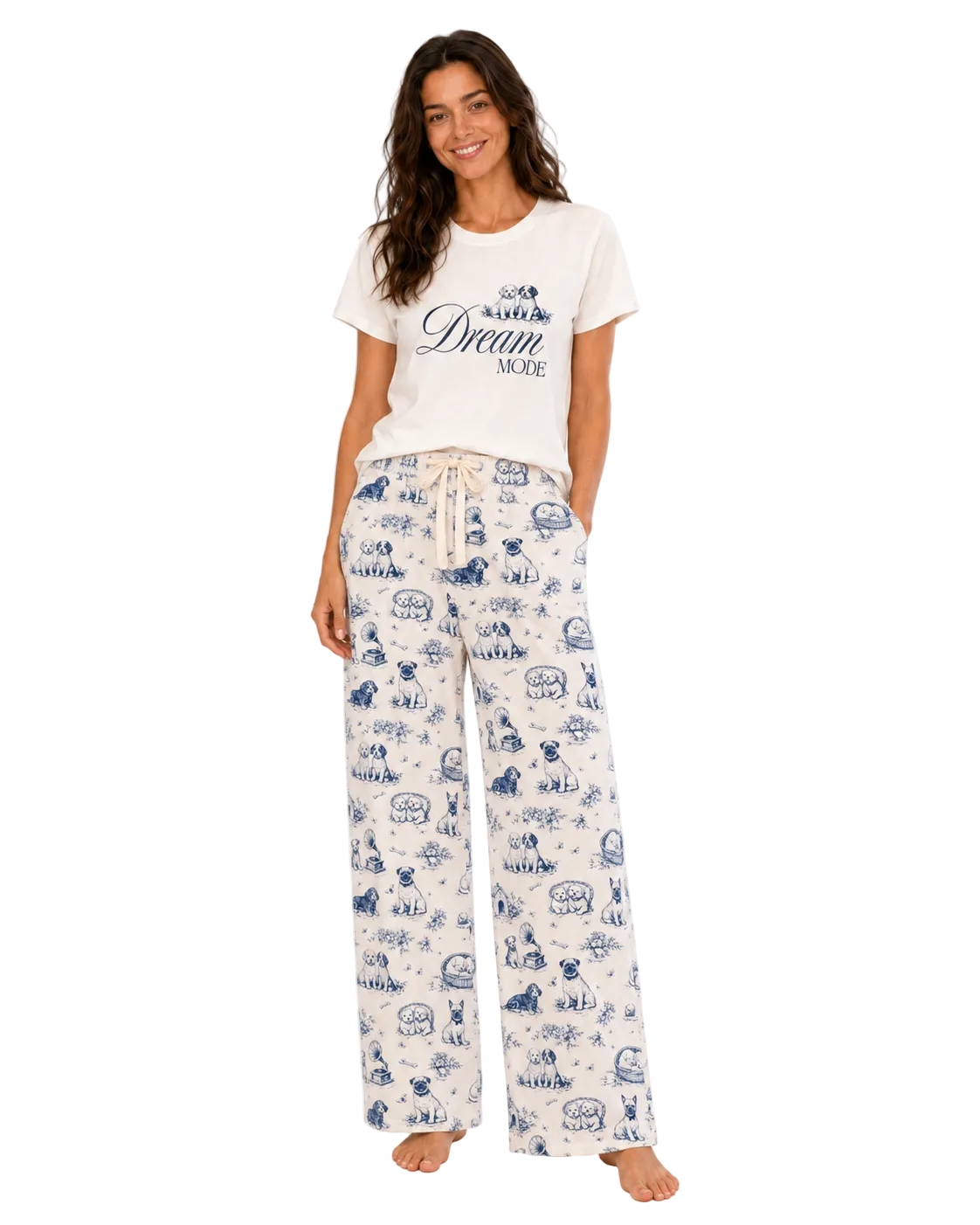 A woman modeling a matching sleepwear set consisting of a white graphic t-shirt and white wide-leg pajama pants with a blue cartoon print, set against a plain white background.
