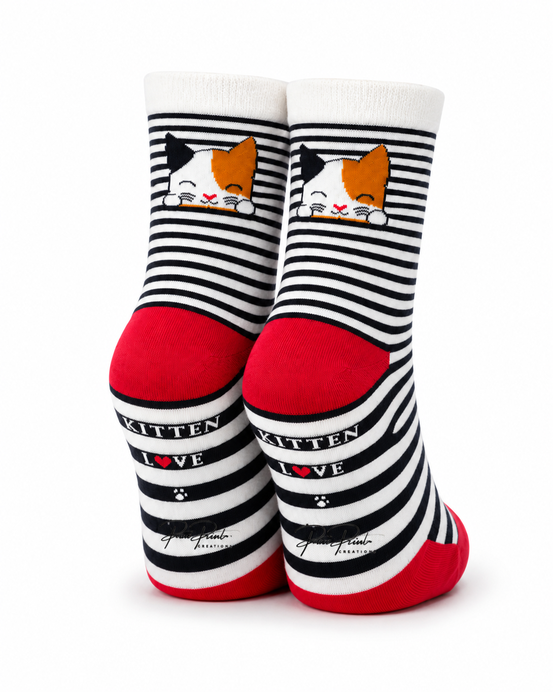 A pair of crew socks with black and white horizontal stripes, featuring a cartoon calico cat face near the cuff, red heels and toes, and the words 'KITTEN LOVE' printed on the sides.